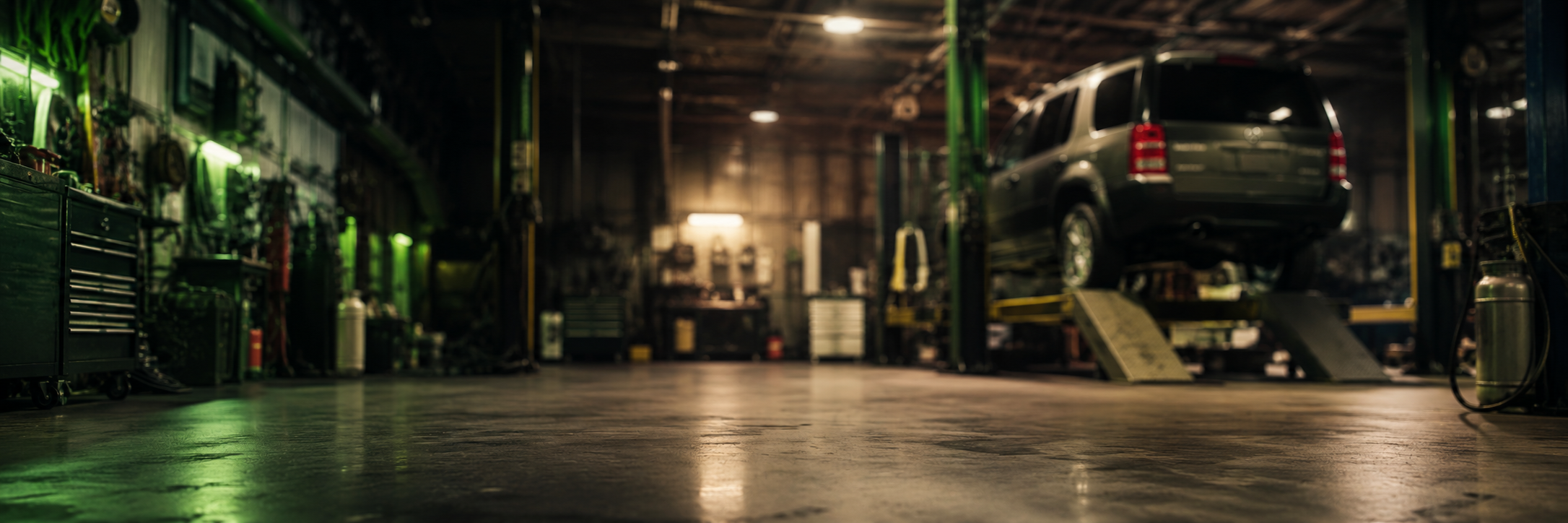 Blurred Land Rover workshop background with Discovery 3 on ramp for repair outcome quote card
